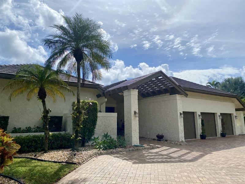 Textured stucco estate with refinished garage doors